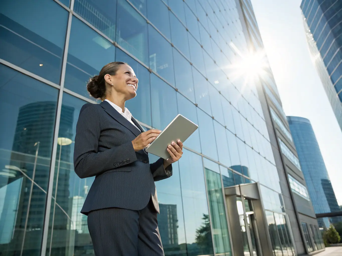 An image of a confident South African woman in a business suit, standing in front of a modern office building in Johannesburg, symbolizing leadership and success.